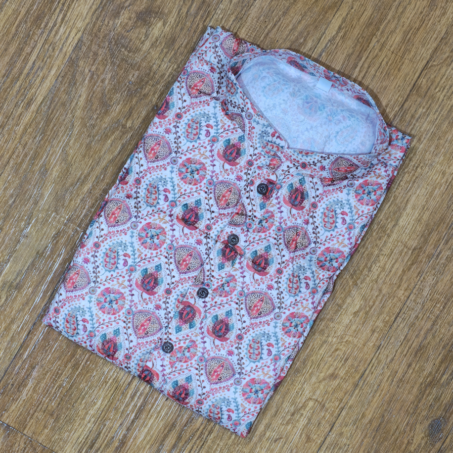 Folded mandarin collar shirt with multicolor floral and paisley block print on wooden floor