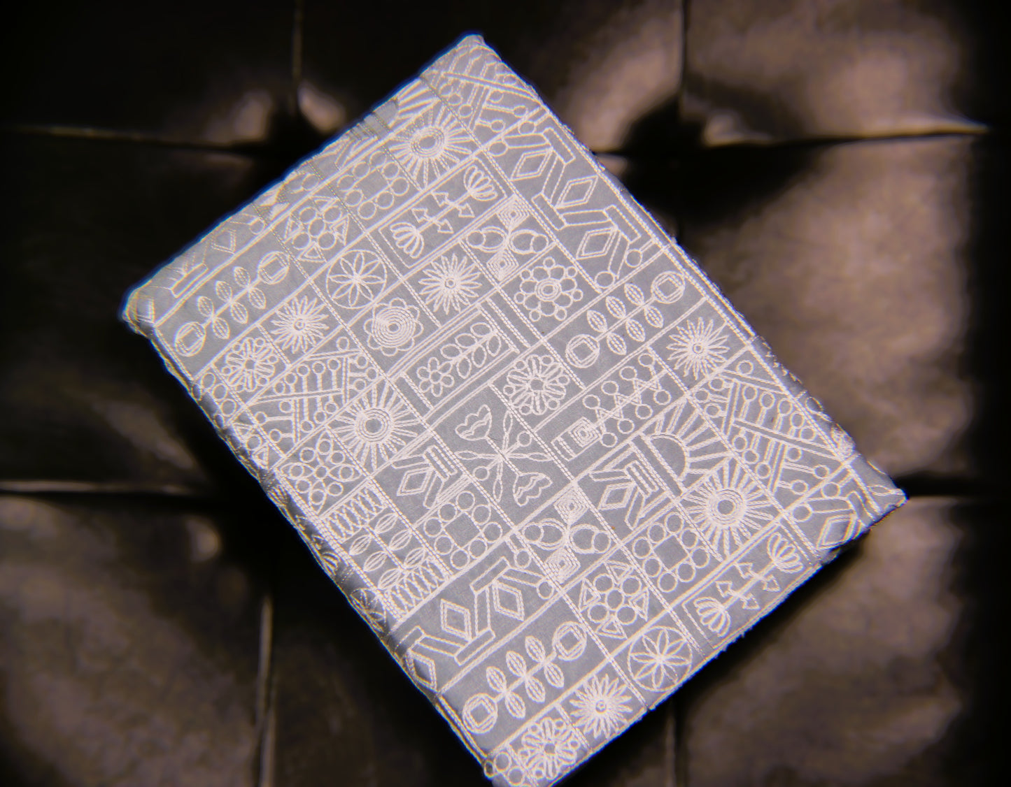 Card with a white geometric pattern on a dark background