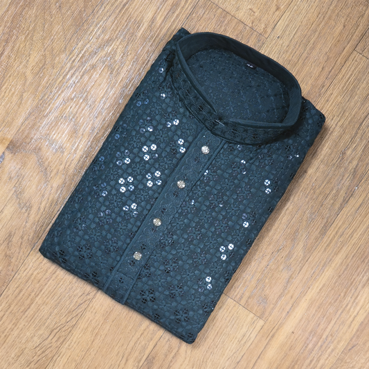 Folded blue sequin shirt on a wooden floor