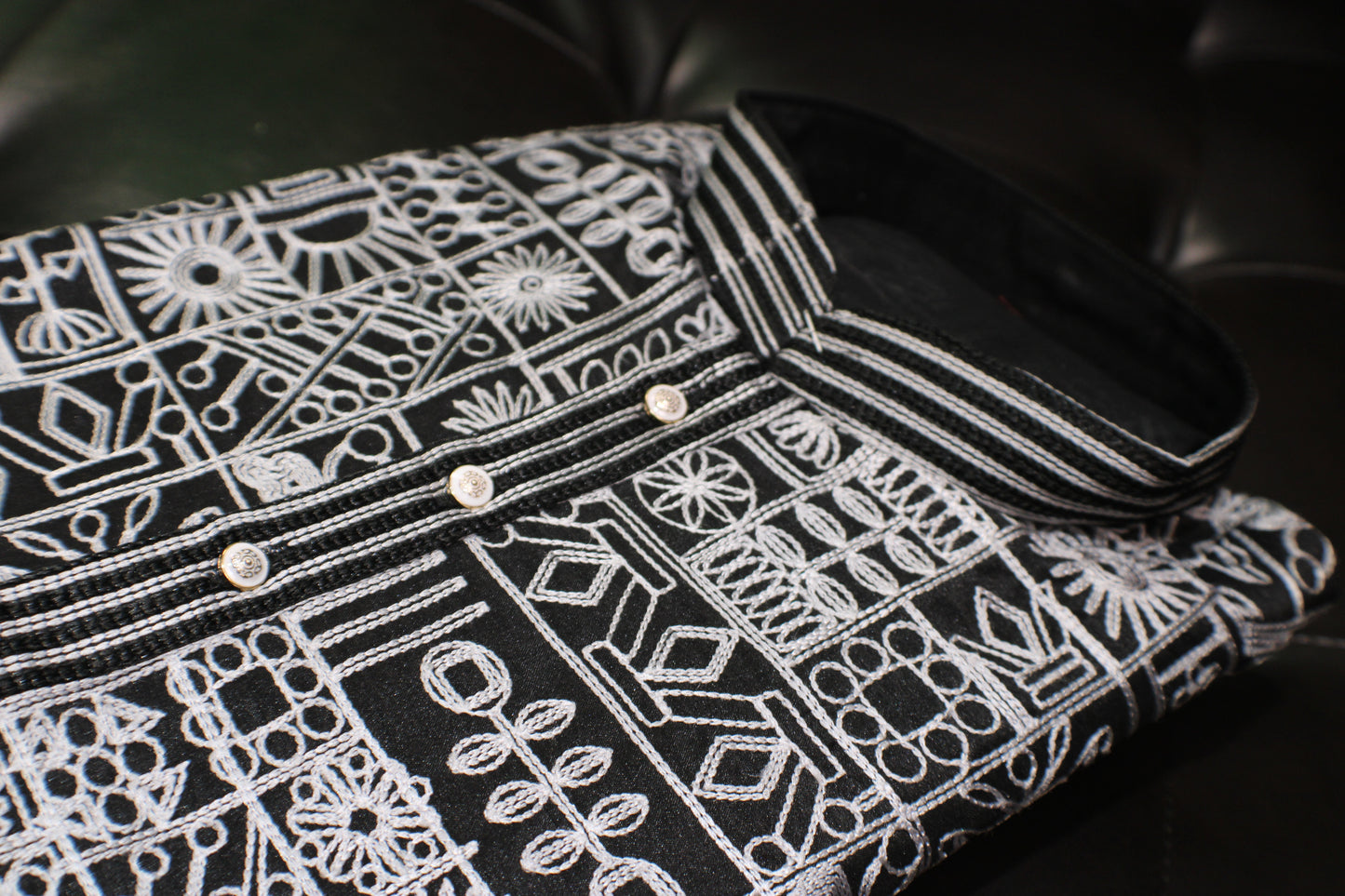 Black shirt with white geometric pattern on a black background