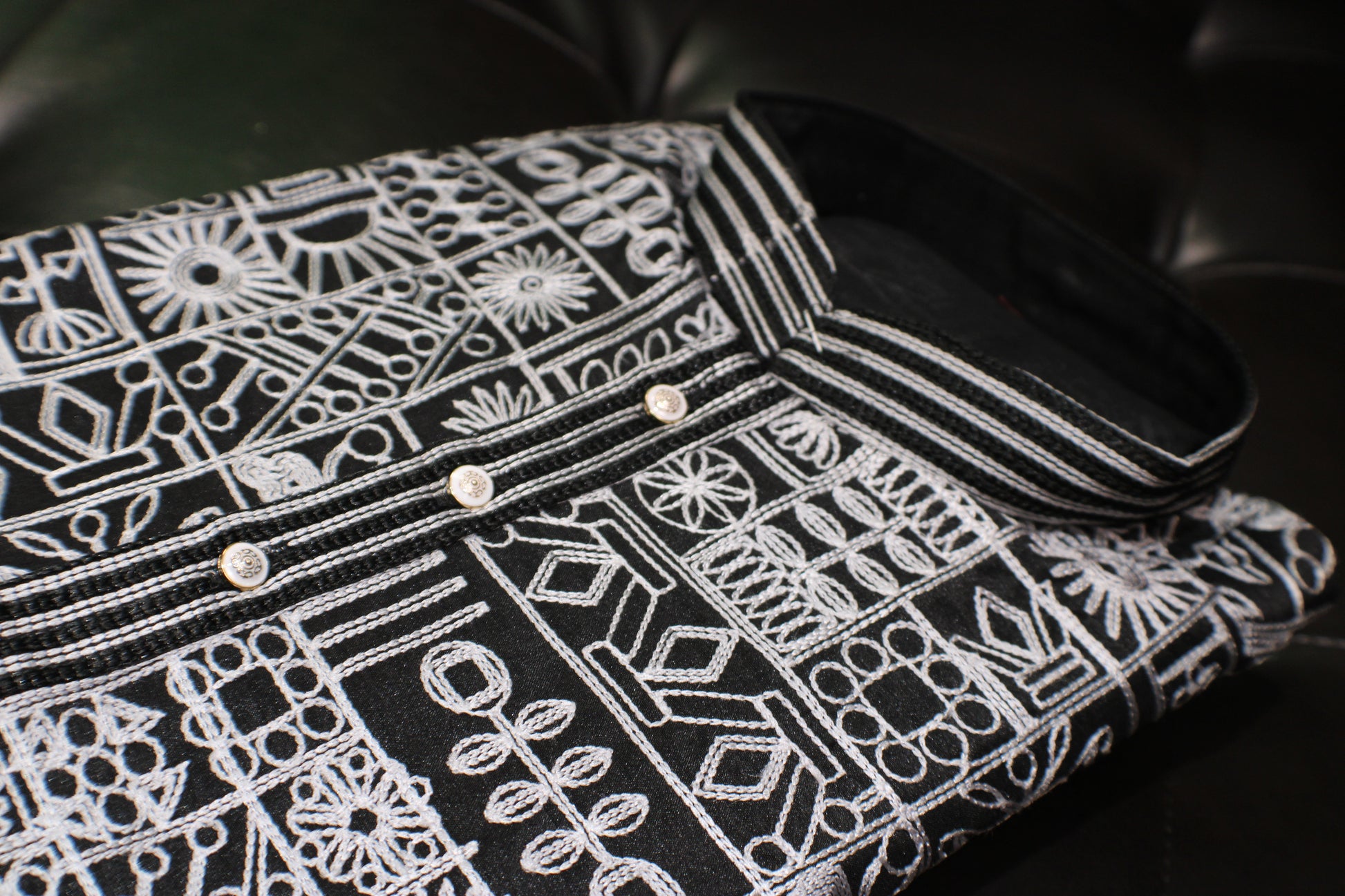 Black shirt with white geometric pattern on a black background