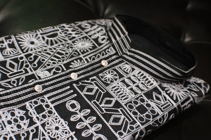 Black shirt with white geometric pattern on a black background