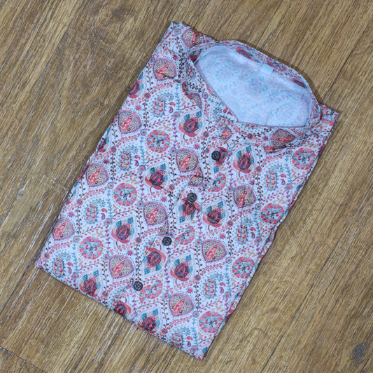 Folded mandarin collar shirt with multicolor floral and paisley block print on wooden floor