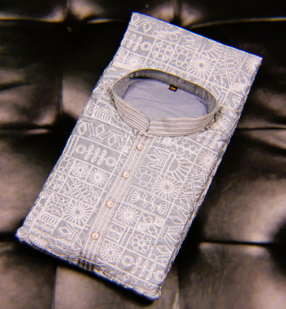 Folded shirt with intricate patterns on a dark fabric background