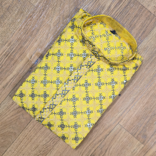 Yellow fabric with black and white pattern on a wooden floor